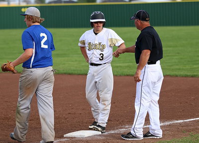 Image: Eli Garcia(3) receives a fist bump from Coach Cate with Garcia representing the winning run on first. Celis then entered the game to pinch run for Garcia.