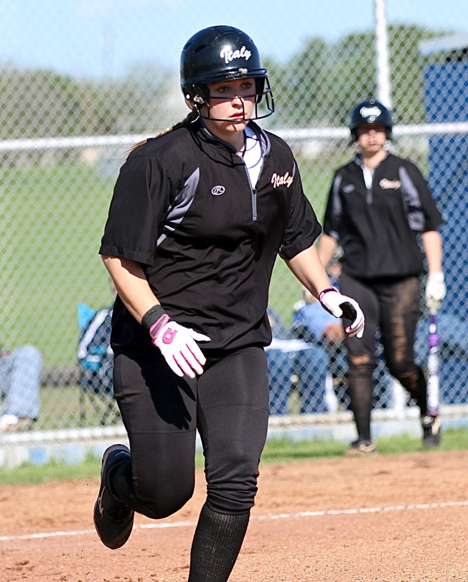 Image: Italy pitcher Jaclynn Lewis(15) gets on base with a walk. April Lusk takes her place as a pinch runner.