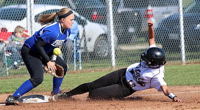 Image: April Lusk(18) slides successfully into third-base, beating the throw.
