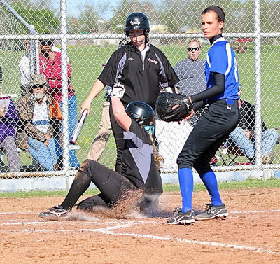 Image: Batter Paige Westbrook(10) steps back as Madison Washington(2) slides in on a wild pitch by Frost. Washington pulls Italy within 1 run with the score 3-2.