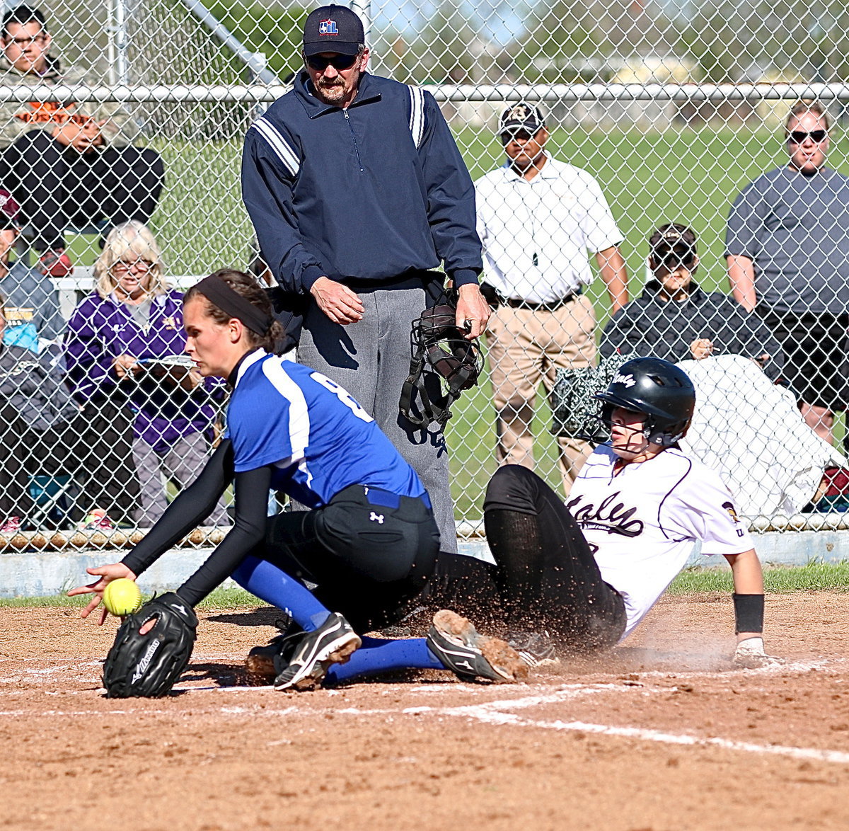 Image: Lillie Perry(9) takes advantage of another wild pitch by Frost and slides into home. Perry ties the game 3-3 in the top of the fourth-inning.