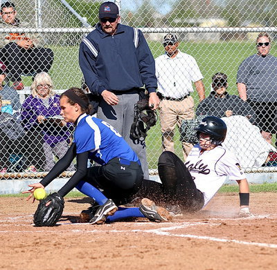 Image: Lillie Perry(9) takes advantage of another wild pitch by Frost and slides into home. Perry ties the game 3-3 in the top of the fourth-inning.