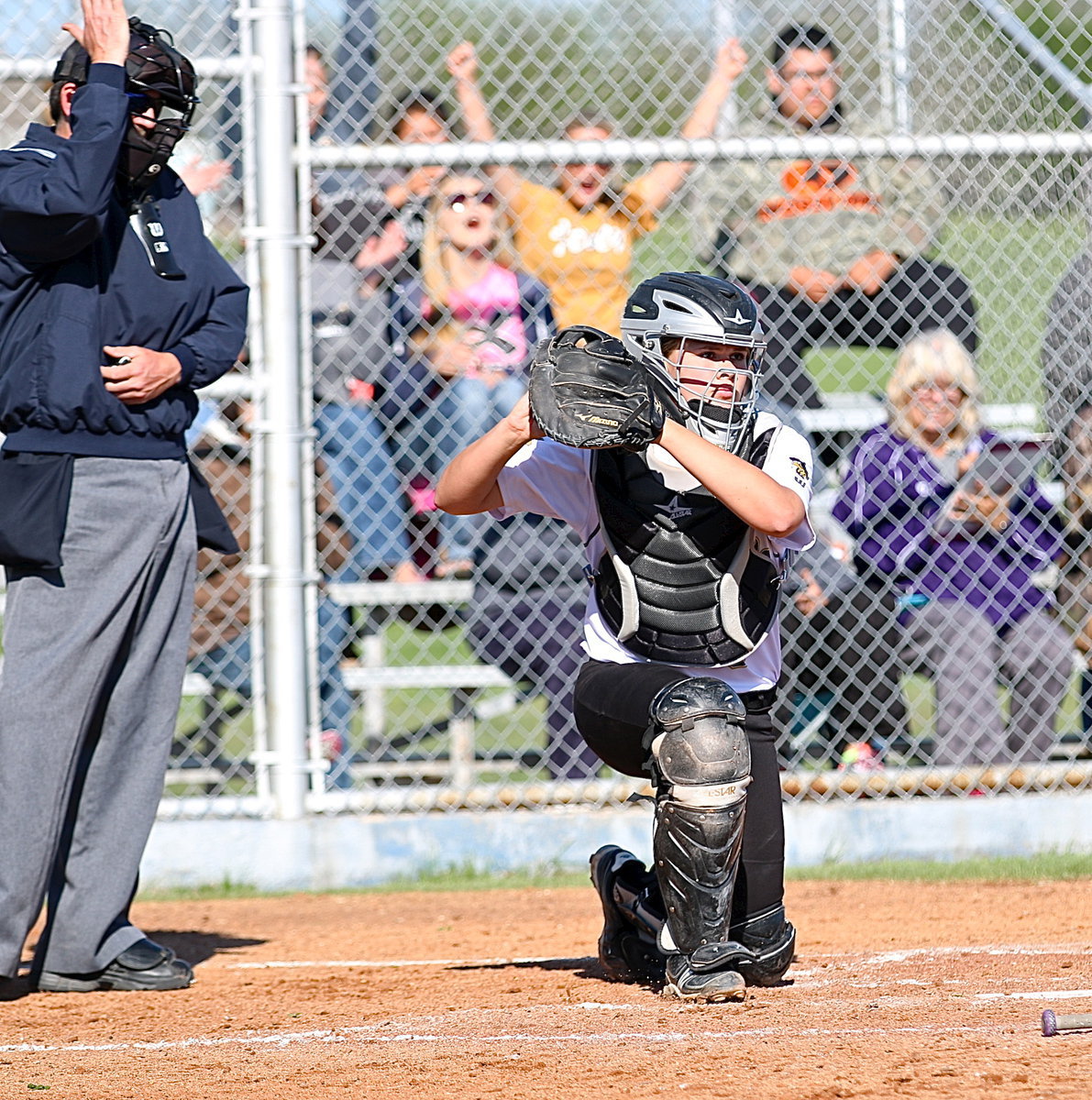 Image: Italy catcher Lillie Perry(9) gets her mitt under a foul tip that glances off her shoulder for an out, and Italy’s fans love it!