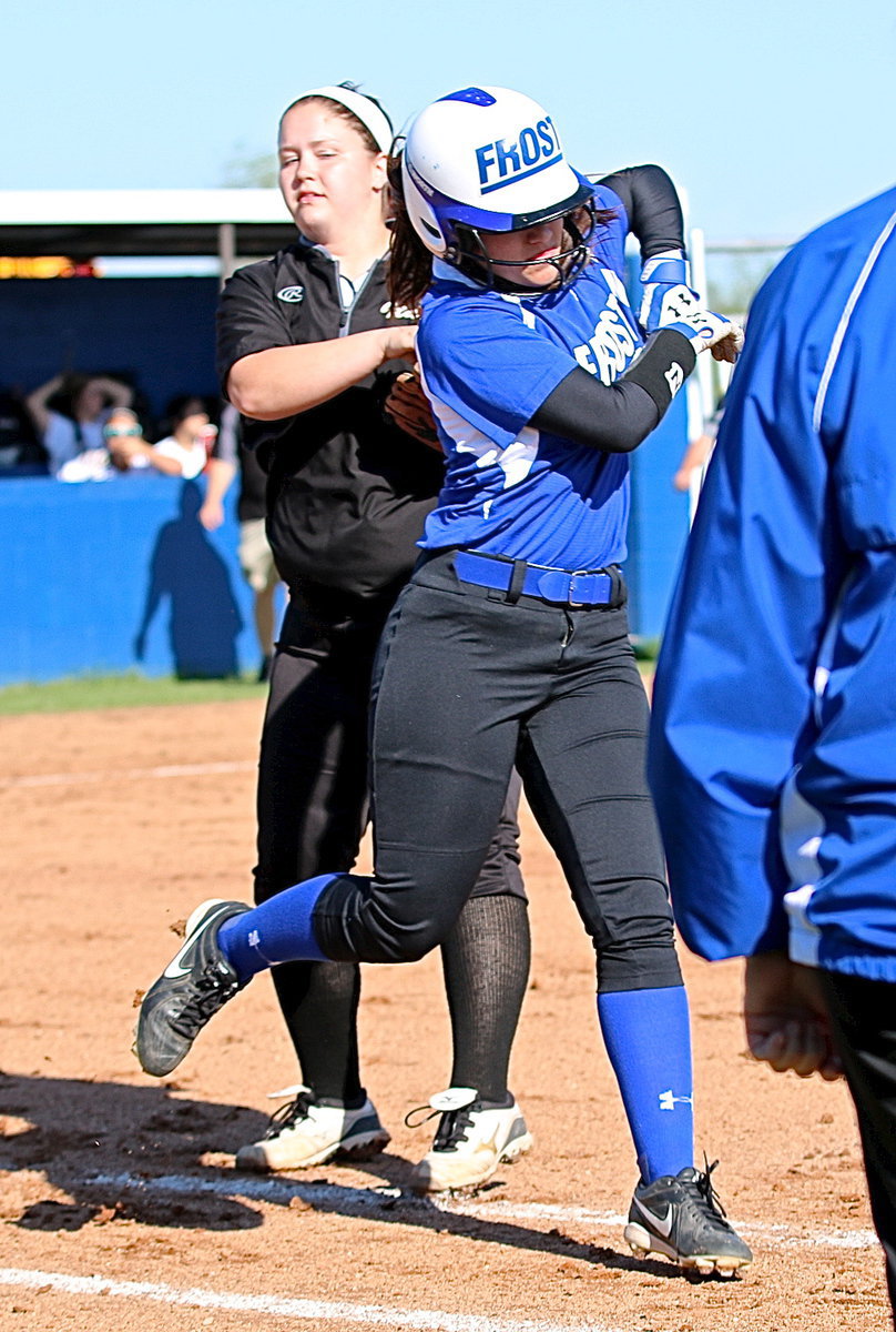 Image: Lady Gladiator first-baseman Paige Westbrook(10) tags a passing Frost runner for an out while avoiding a flailing elbow.