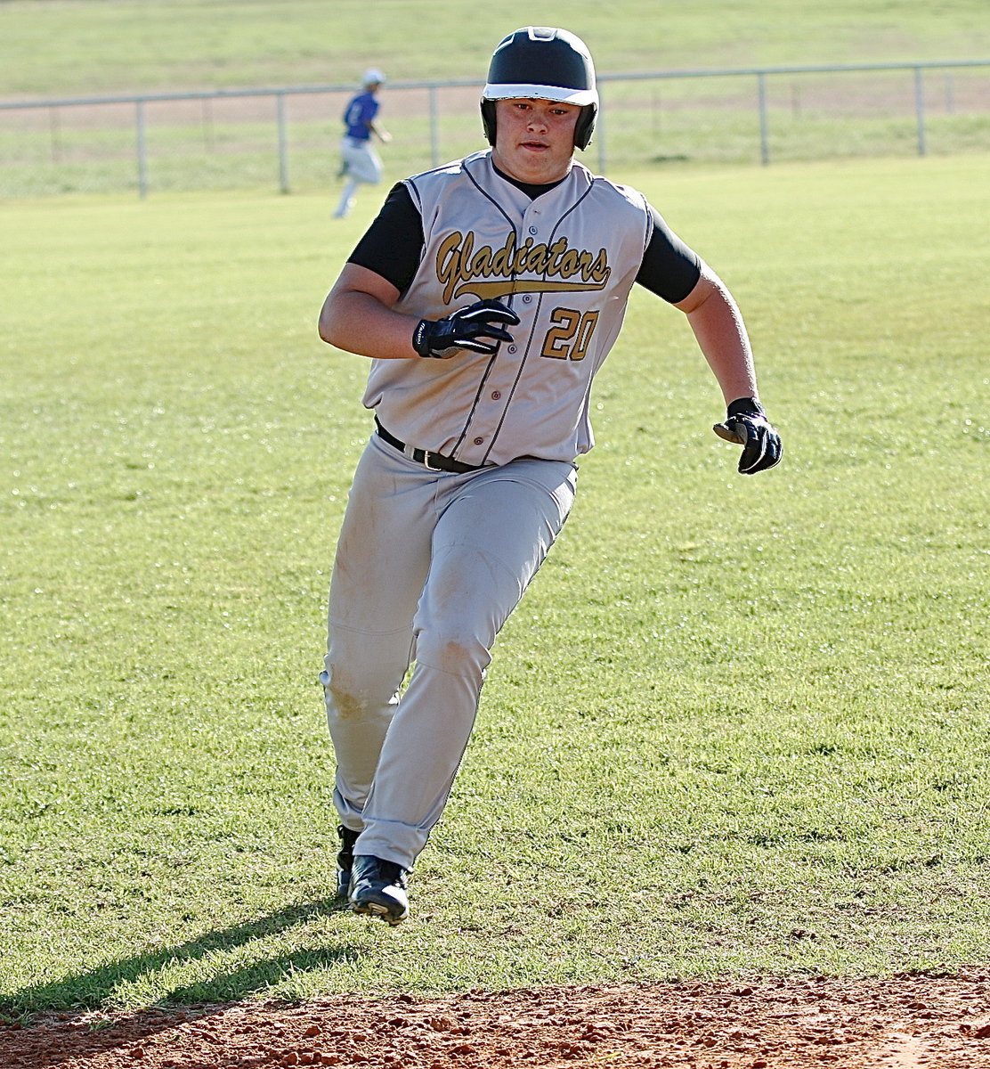 Image: Zain Byers(20) rounds third and hurries home thanks to a double from teammate Levi McBride.