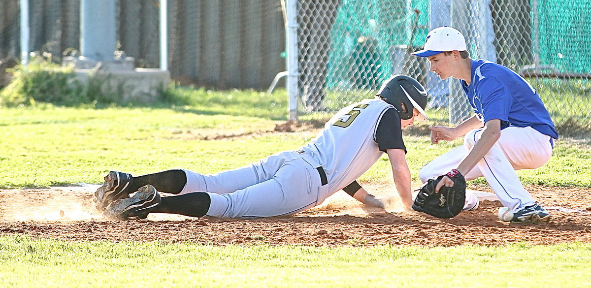 Image: Cody Boyd(15) makes it back to first-base with no problem.