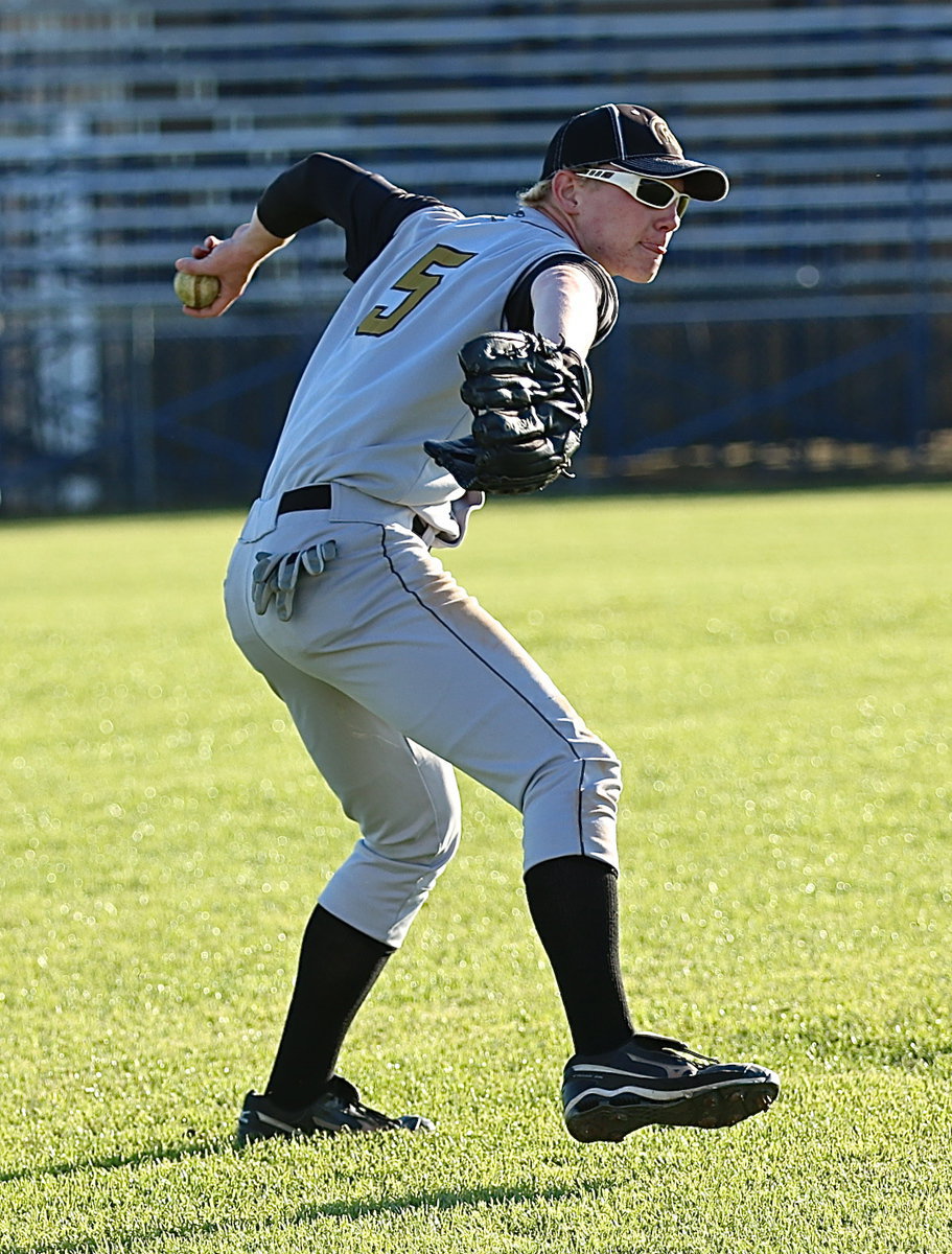 Image: Cody Boyd(5) covers a ball hit into left field.