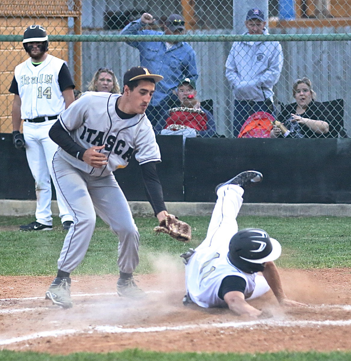 Image: Tyler Anderson(11) avoids the tag after reaching home plate via a wild pitch. Mom, Amy Anderson, loves it and so does Jason Escamilla with a fist pump behind the fence.