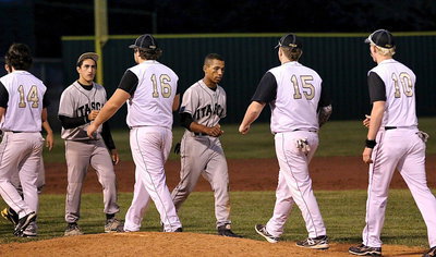 Image: With the game called in the fifth-inning after Italy run-ruled Itasca 10-0, Kyle Fortenberry(14), Kevin Roldan(16), Tyler Vencill(15) and Cody Boyd(10) display sportsmanship across the mound.
