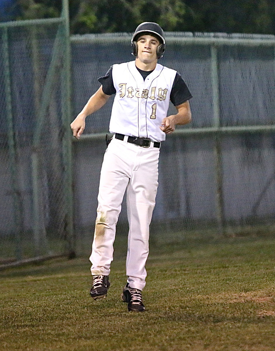 Image: Levi McBride(1) unwillingly slows up to play it safe down the third-base line.