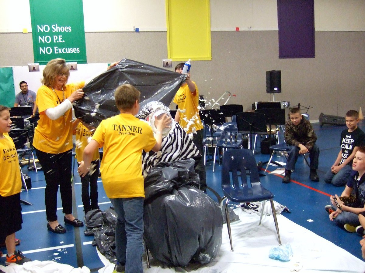 Image: Tanner Chambers seems to be having too much fun smashing that pie in Mrs. Garcia’s face.