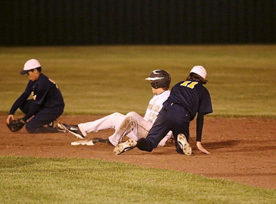 Image: Bailey Walton(17) slides his way onto second-base to beat the throw down.