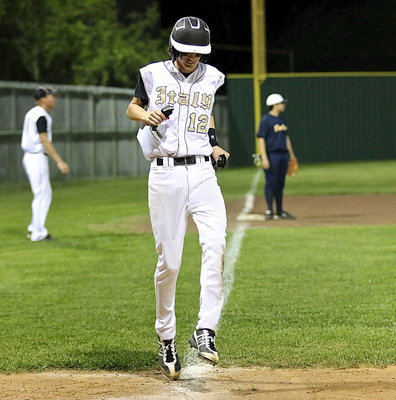 Image: Ty Windham(12) dances his way across home plate as the game winning runner batted in by teammate Levi McBride.