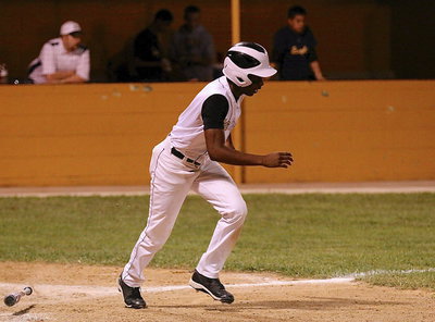 Image: Eric Carson(2) hits his way onto first-base for the Gladiators.