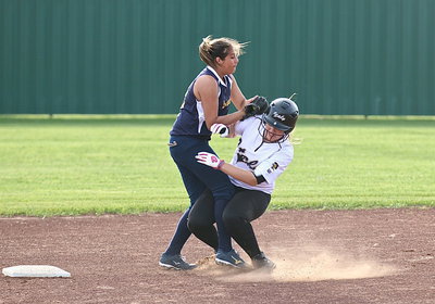 Image: Jaclynn Lewis(15) collides with GPAAs second-baseman and appears to be out but the Lady Eagles were charged with base obstruction allowing Lewis to return to fist-base.