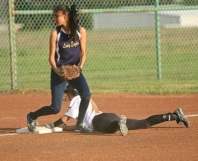 Image: After the dust settles, Britney Chambers(4) is ruled safe at third after a head-first dive.