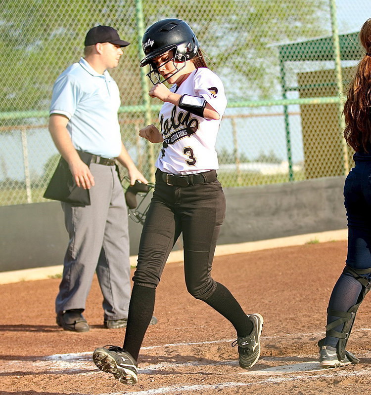 Image: Cassidy Childers(3) makes it home to score a run for the Lady Gladiators.