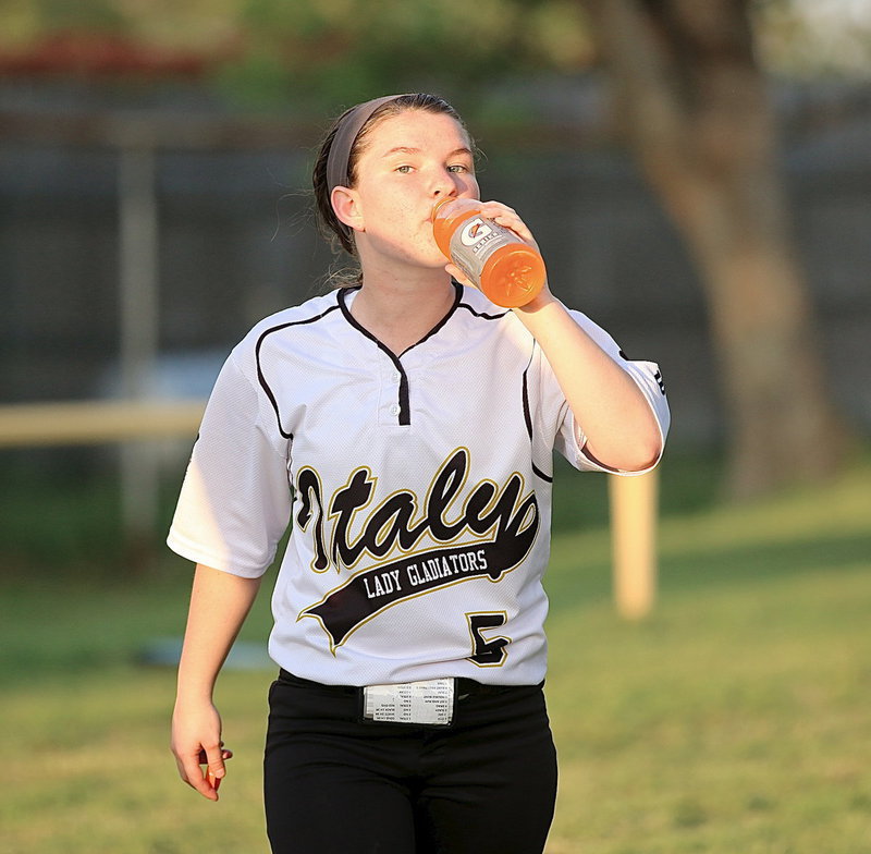Image: After the Lady Gladiators win game one, 10-0, against GPAA, Tara Wallis(5) gets refreshed before the start of game two.
