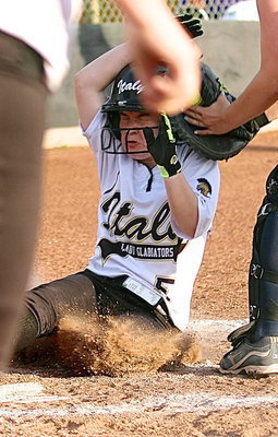 Image: Tara Wallis(5) takes the tag to the helmet after she had beat the throw home.