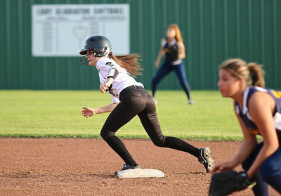 Image: Lady Gladiators Cassidy Childers(3) takes off wanting to reach third-base.