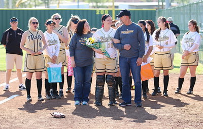 Image: Senior Lady Gladiator Paige Westbrook(10) prepares to walk out with her parents Angie Westbrook and Kelly Westbrook with her teammates backing her and her family up in support.
