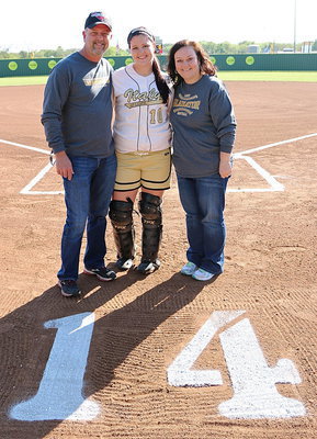 Image: Proud parents Kelly Westbrook and Angie Westbrook pose with their daughter Paige Westbrook(10) who is about to play her final home game as a Lady Gladiator softball player.