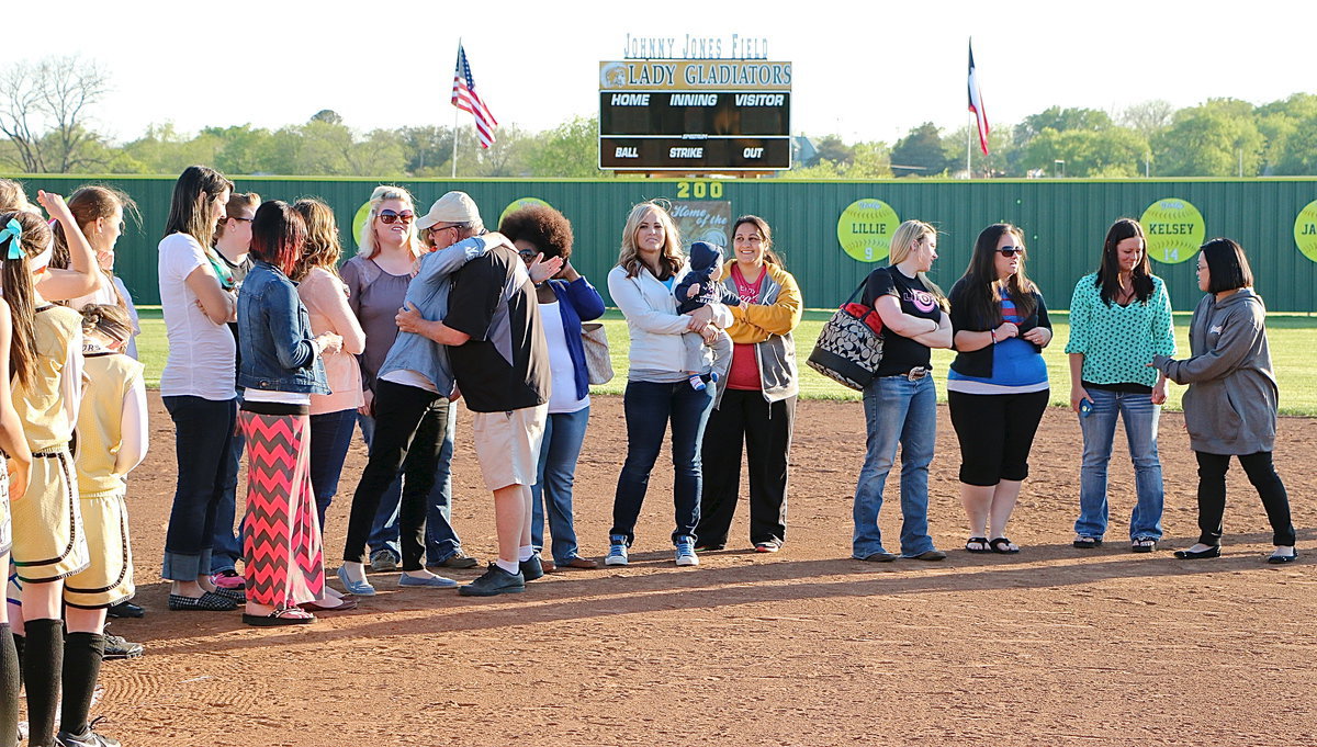 Image: Sarah DeMoss gives Coach Jones a hug and a pat on the back.