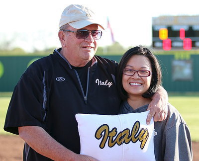 Image: Coach Johnny Jones and his daughter JoAnn Jones-Miller after the unveiling of his name atop the Lady Gladiator scoreboard. The Italy softball field was officially named Johnny Jones Field on Tuesday, April 15, 2014. The pillow he is holding was made with the very first jersey that the Lady Gladiators wore back in 1998.