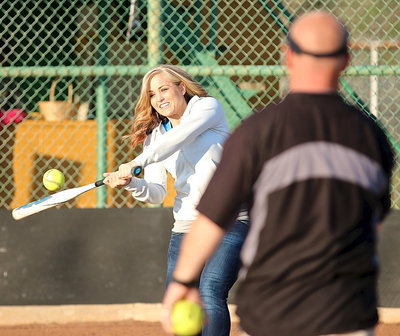 Image: Just like old times! Courtnie Threadgill shows that she still has her all-state form while tapping a few pitches from Lady Gladiator assistant softball coach Michael Chambers.