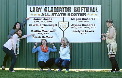 Image: Here’s my name! Her’e mine!! Italy’s all-state players point out their names on a banner recently mounted on the outfield fence to honor their accomplishments.