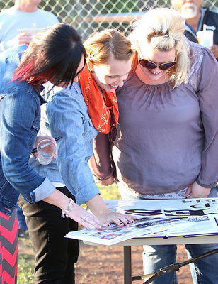 Image: Crystal Langley-Lopez, Sarah DeMoss-Fulfer and Christie Carter-Enriquez enjoy perusing thru the old yearbooks and team photos.
