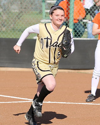 Image: Lady Gladiator Tara Wallis(5) hustles out to the diamond after being introduced before the start of the game.