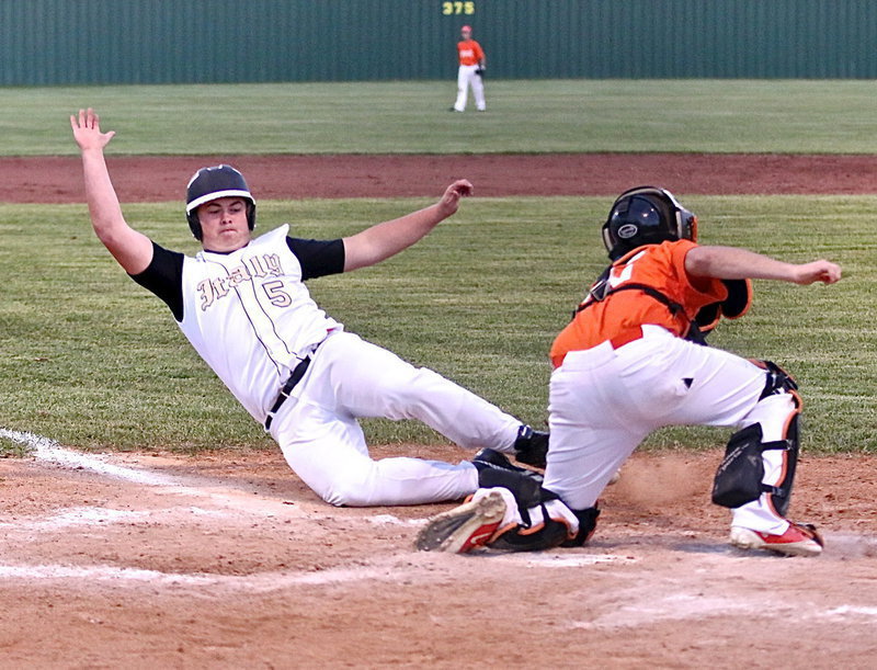 Image: Zain Byers(5) slides safely into home but Avalon’s catcher gets injured on the play.
