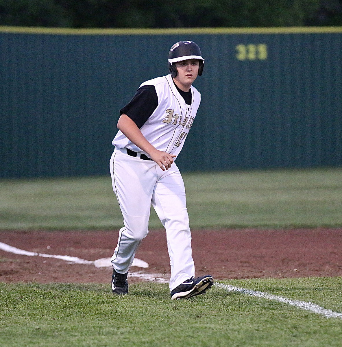 Image: Senior Bailey Walton(17) plots his path to the plate.