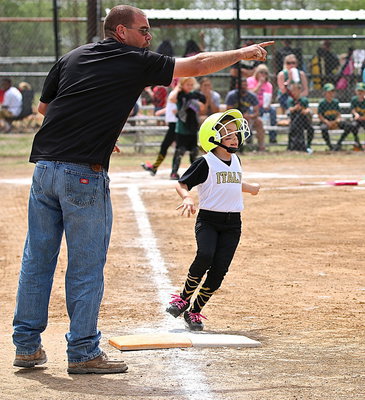 Image: Coach Brad Chambers directs his daughter, Morgan Chambers, to the next base.