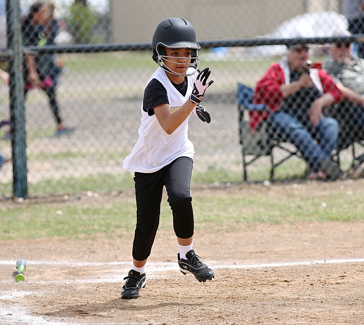 Image: Aliyah Turner connects on the ball and then hustles to first-base.