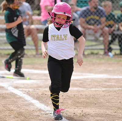 Image: Kinley Cate is on her way to first after a big hit.
