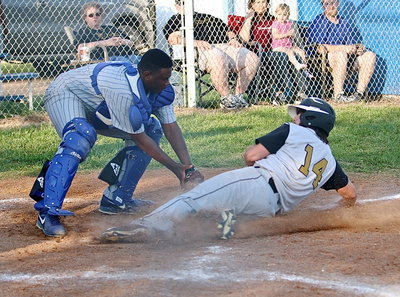 Image: Not this time! Milford catcher Jacarvus Gates(7) denies Italy’s Kyle Fortenberry(14) from scoring a run.