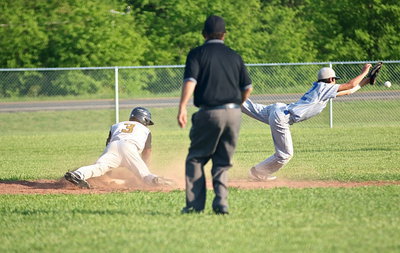 Image: Italy’s Eric Carson(3) slides under the throw to Milford’s Daren Cisneros(12) at second-base and then Carson heads for third on the overthrow.