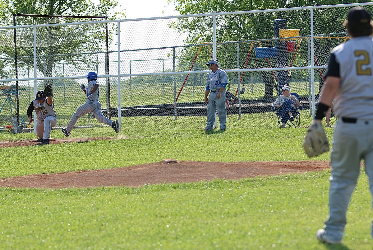 Image: Again, John Byers(21) covers a ball down the third-base line and then throws a strike of his own to Kevin Roldan(16) for out #2. Needless to say, it takes two to tango and Roldan was perfection on Friday against the Bulldogs.