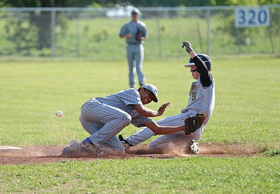 Image: Junior Gladiator Cody Boyd(5) power slides thru a near tag by Milford’s Devonteh Williams at second-base. With district implications on the line, close encounters were cropping up all over the playing field.