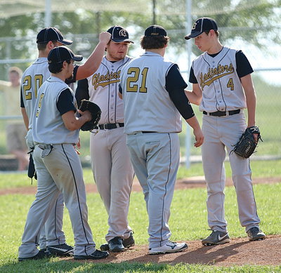 Image: Ryan Connor(4) receives support from his infielders John Byers(21), Kevin Roldan(16), Tyler Anderson(9) and Zain Byers(20).