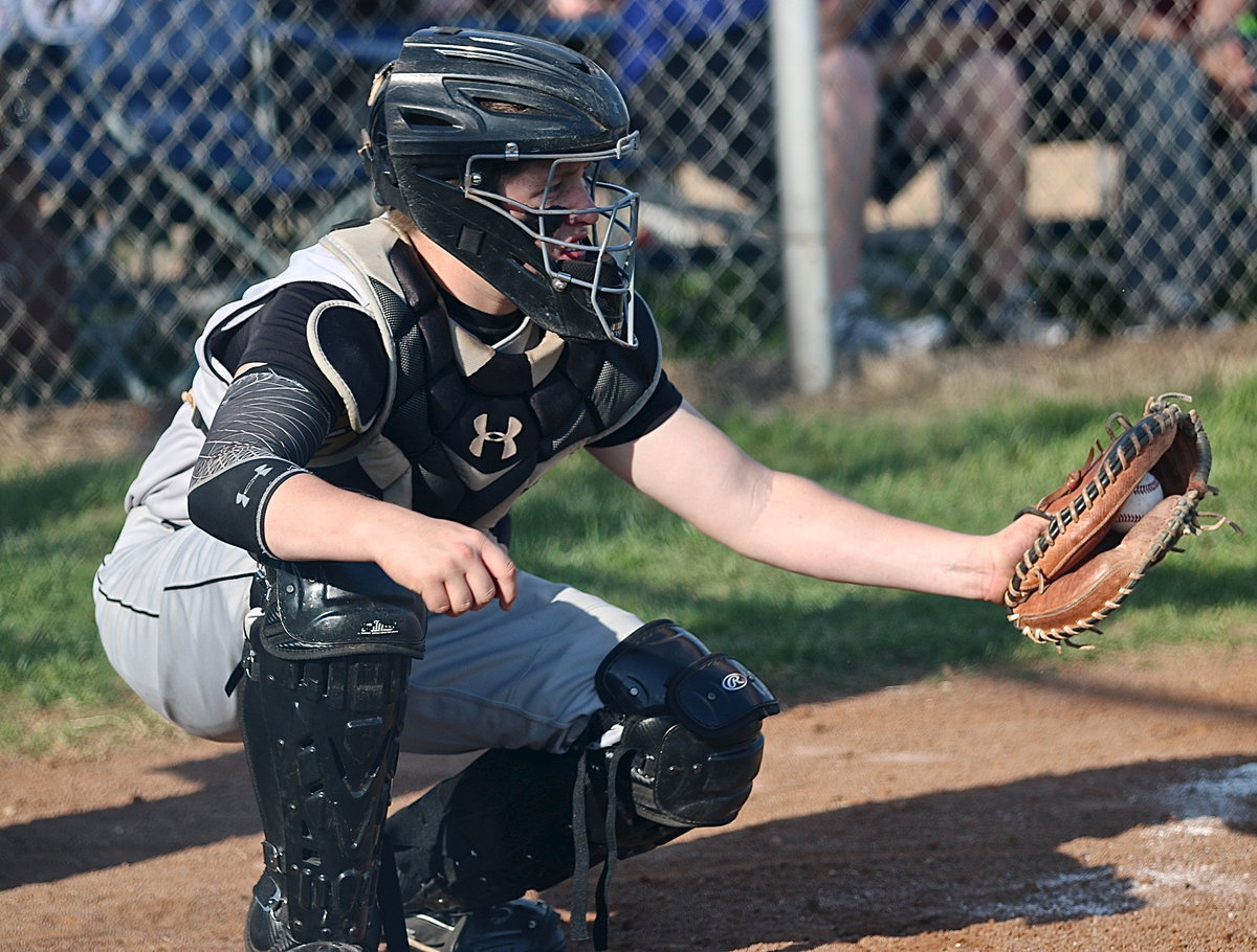 Image: Gladiator catcher John Escamilla(7) hauls in a strike against the Bulldogs.