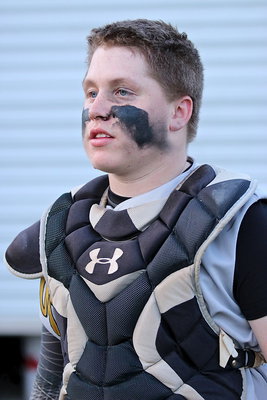 Image: It’s a dirty job but somebody has to do it. Gladiator junior John Escamilla(7) has overcome injuries to be one of the top catcher’s in the district while having the best seat in the house to witness his Gladiators claim the championship outright with an 11-6 win over Milford.