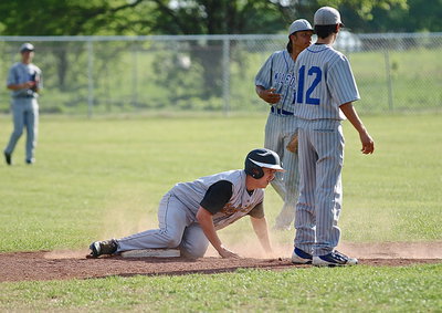Image: Bailey Walton(13) slides across second-base with Milford’s defense taking no chances.