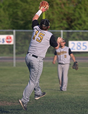 Image: Gladiator third-baseman Tyler Vencill(15) leaps for the relay throw from his outfielders.