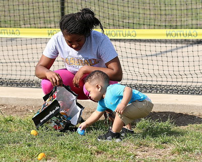 Image: Jaiden Saxon with his mom Jameka plays a little football with an egg.
