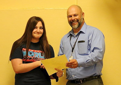 Image: FCCLA member Alexis Sampley is presented a plaque and a certificate by Italy ISD Principal Lee Joffre for her 6th place finish at the state level among big and little schools as an Environmental Ambassador.