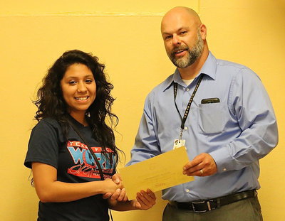 Image: FCCLA member Julissa Hernandez is presented a plaque and a certificate by Italy ISD Principal Lee Joffre for her 6th Place finish at the state level among big and little schools as an Environmental Ambassador.