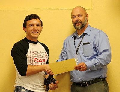 Image: FCCLA member Chace McGinnis is presented a plaque and a certificate by Italy ISD Principal Lee Joffre for his 4th place finish at the state level among big and little schools for Presentation and Sports Nutrition.
